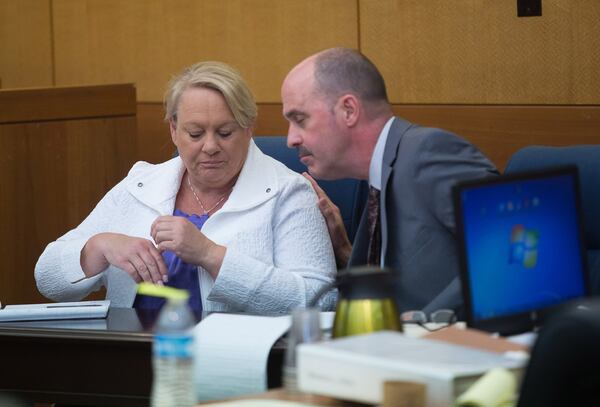 Attorney Reid Thomson (right) talks with defendant Mye Brindle while Brindle’s former employer Joe Rogers Jr. testifies during Day 3 of their trial at the Fulton County Courthouse on April 5, 2018. STEVE SCHAEFER / SPECIAL TO THE AJC