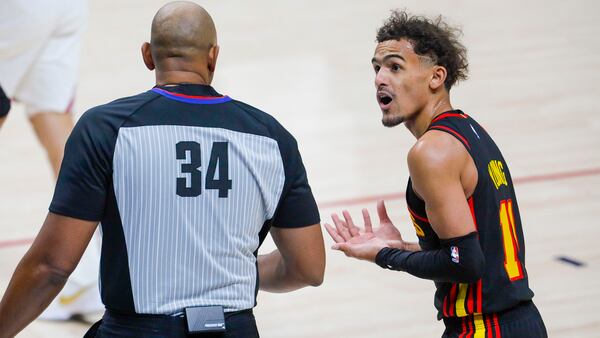 Atlanta Hawks guard Trae Young (11) argues a call with referee Kevin Cutler (34) against the Denver Nuggets in the first quarter Sunday, March 28, 2021, in Denver. (Joe Mahoney/AP)