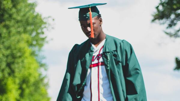 In high school, Michael Harris wore his favorite team's jersey beneath the graduation gown. (Photo courtesy Harris family)