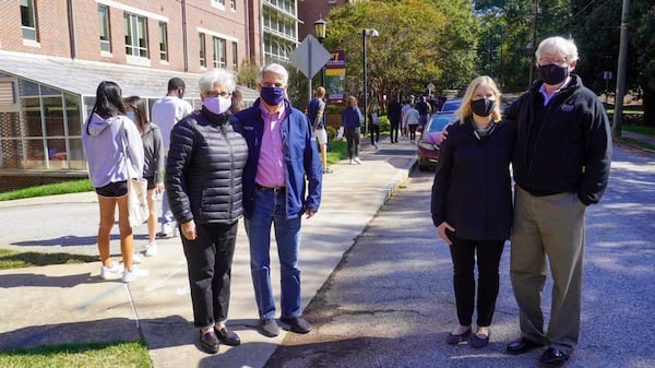 Emory University President Gregory Fenves, wearing blue jeans, and his wife, Carmel Martinez Fenves, join Agnes Scott College President Leocadia "Lee" Zak, and her husband, Kenneth Hansen, as some Emory students waited in line for early voting on the Agnes Scott campus. PHOTO CREDIT: Agnes Scott College and Emory University.