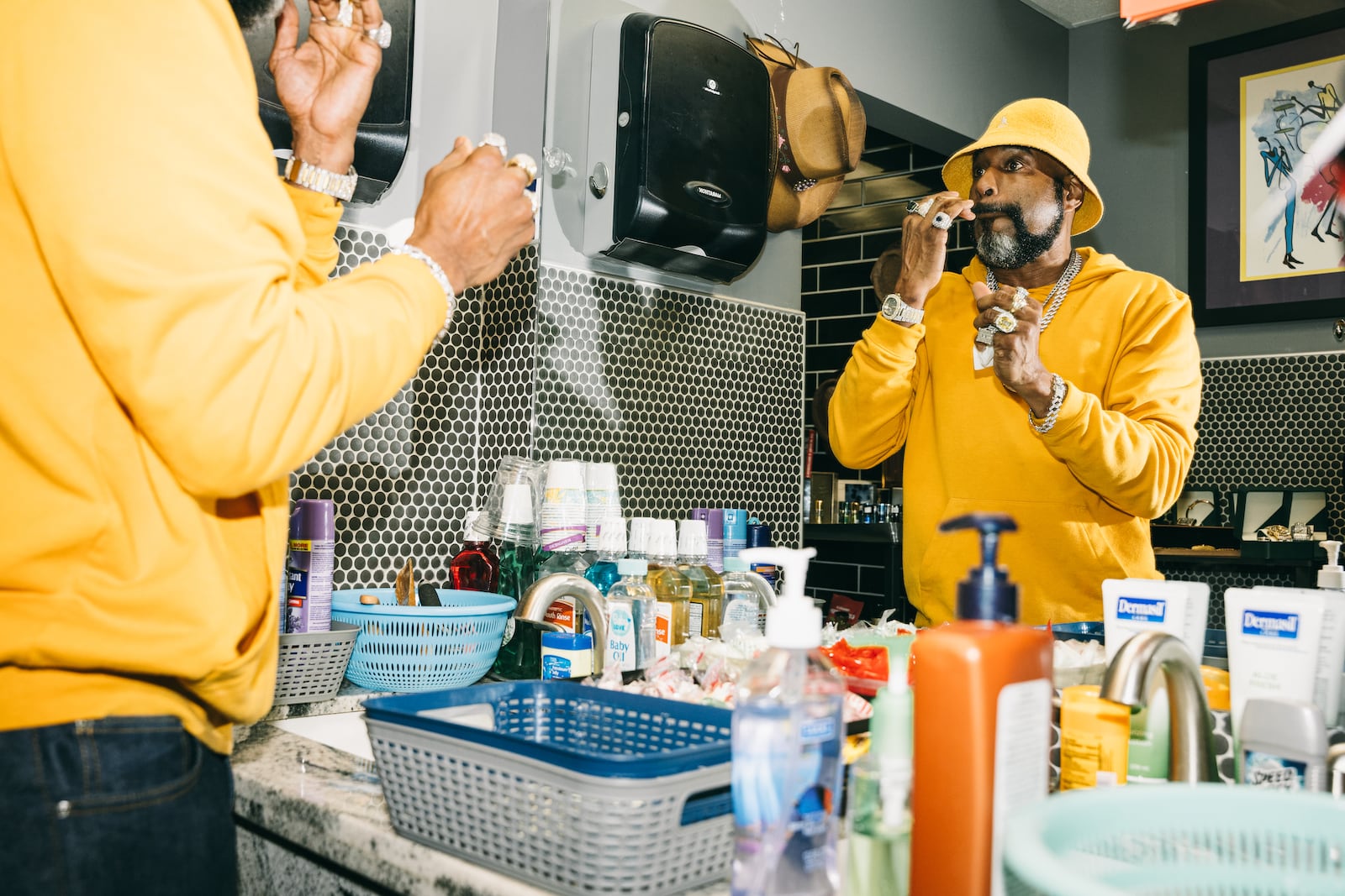 Stacy K Williams, age 54, freshens up at the 'bathroom valet' in Ellery's Night Club and Lounge in southwest Atlanta on Wednesday, Feb. 21, 2024. (Olivia Bowdoin for the AJC).  