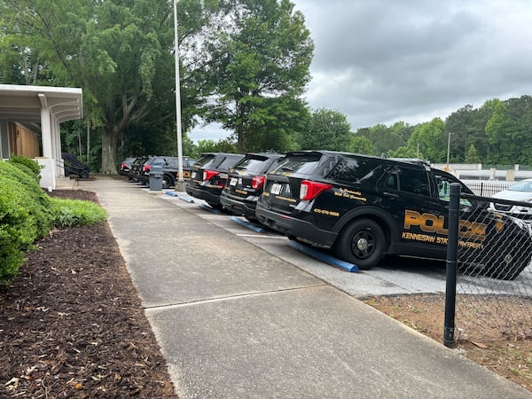 Several Kennesaw State University police patrol vehicles are seen in the university's department of public safety parking lot Sunday morning. 