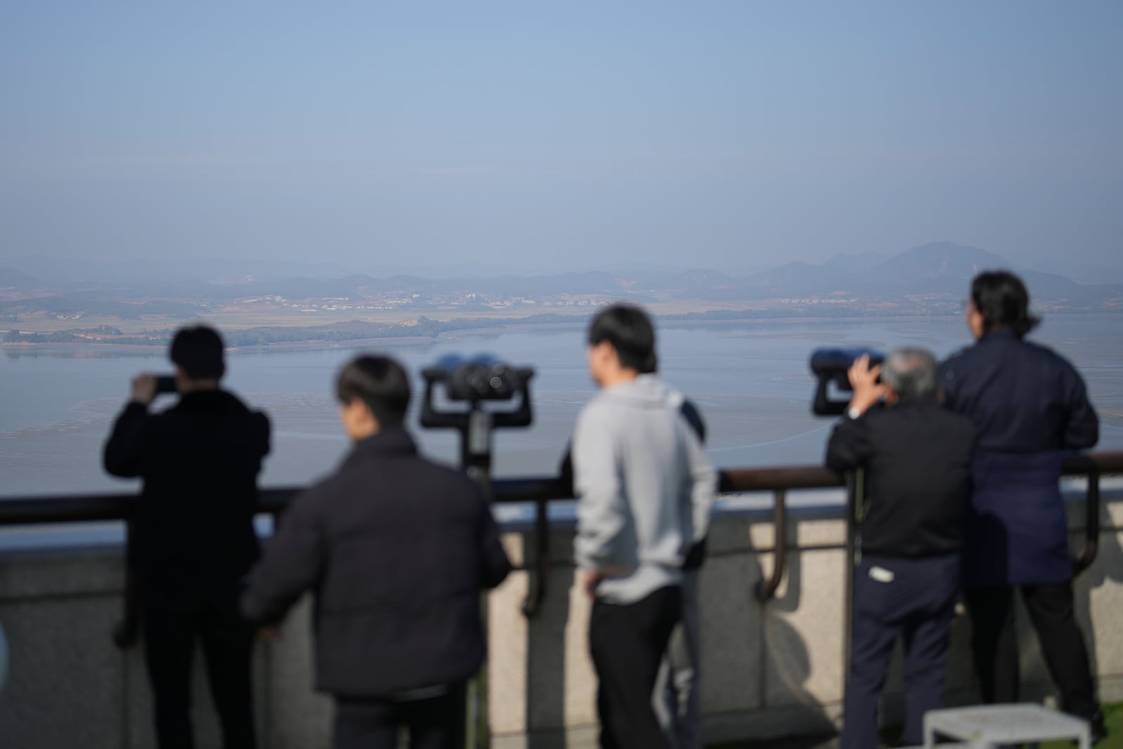 Visitors look at the North Korean side from the unification observatory in Paju, South Korea, Thursday, Oct. 31, 2024. (AP Photo/Lee Jin-man)