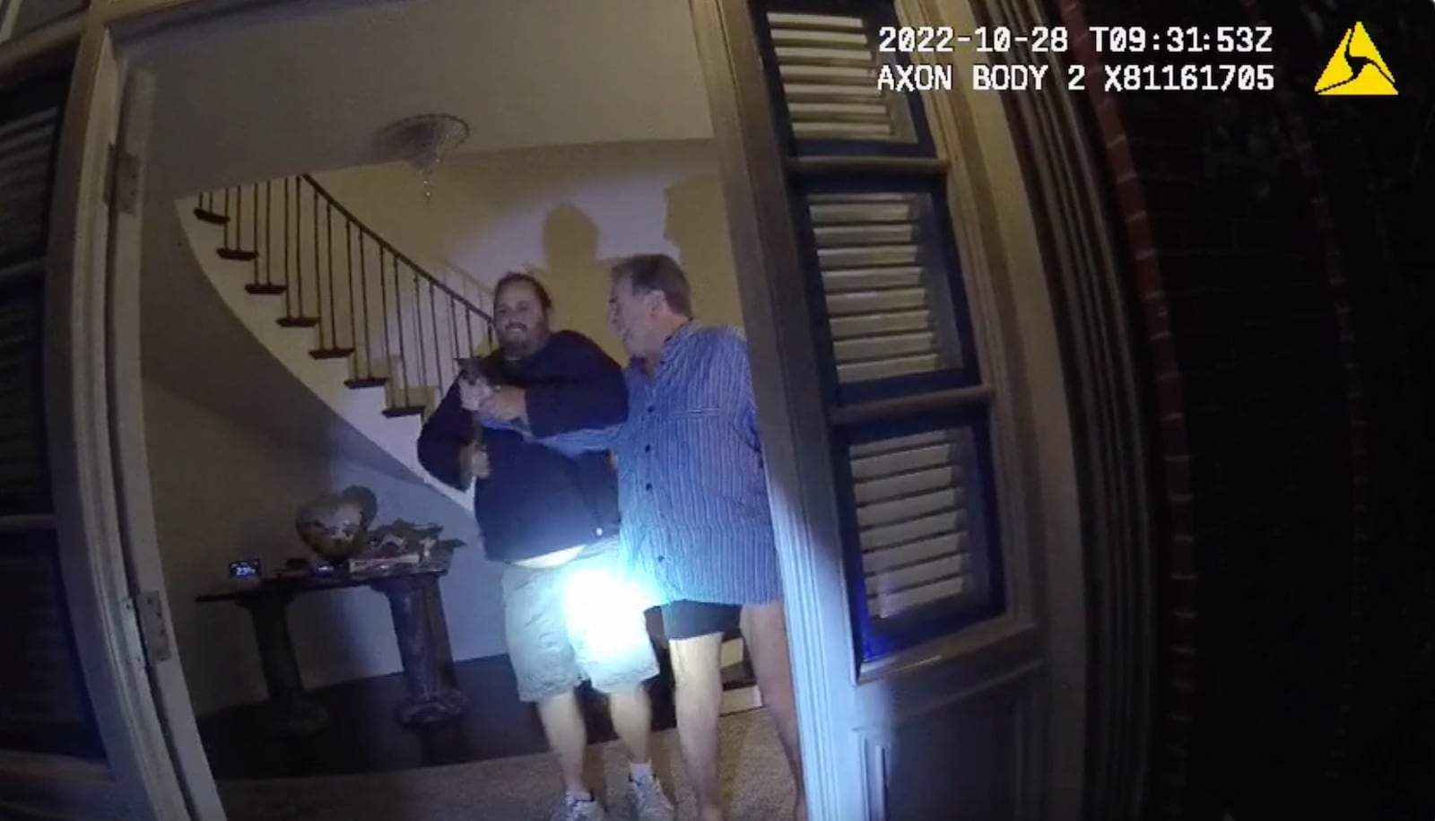 FILE - In this image taken from San Francisco Police Department body camera video, the husband of former U.S. House Speaker Nancy Pelosi, Paul Pelosi, right, fights for control of a hammer with his assailant, David DePape, during a brutal attack in the couple's San Francisco home on Oct. 28, 2022. (San Francisco Police Department via AP, File)