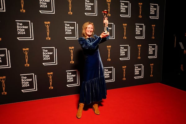 Samantha Harvey poses with the trophy after winning the Booker Prize award 2024, in London, Tuesday, Nov. 12, 2024. (AP Photo/Alberto Pezzali)