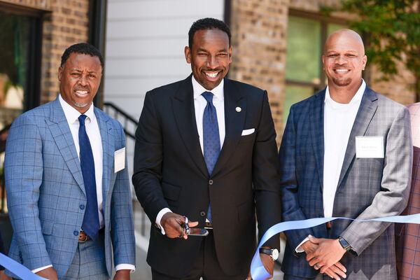 Mayor Andre Dickens (middle) with Atlanta Beltline CEO Clyde Higgs (left) and Edrick Harris of Prestwick Development (right) at the ribbon cutting ceremony for the opening of Parkside, a new affordable housing community. (Natrice Miller / natrice.miller@ajc.com)

