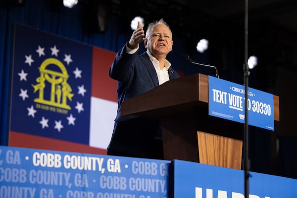 Gov. Tim Walz speaks at a campaign rally Sunday with Kamala Harris' husband, Doug Emhoff, and Jon Bon Jovi in Cobb County. “This game is tied,” Walz said of the tight race for president. “We’ve got two minutes left. We’ve got the damn ball. And we’ve got the best quarterback on the field in Kamala Harris.” (Nathan Posner for the Atlanta Journal-Constitution)