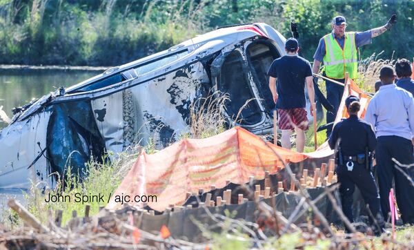 Authorities survey the damage Monday morning. JOHN SPINK / JSPINK@AJC.COM