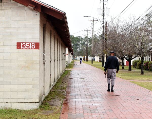 Command Sgt. Maj. Joseph Mayfield, commandant of the Fort Stewart Youth Challenge Academy, walks between buildings during a campus tour in February. Mayfield told the AJC that he’s had “no cadre, since I’ve been the commandant, injure any kids.” But state records reviewed by the newspaper contradict that. RYON HORNE / RHORNE@AJC.COM