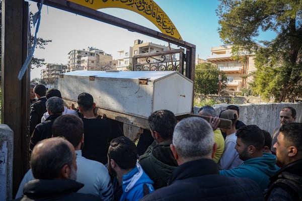 The coffin carrying the body of Nawaf Khalil Baytar, who was killed during the recent wave of violence between Syrian security forces and gunmen loyal to former President Bashar Assad, is carried for burial in Jableh, Syria's coastal region, Monday, March 10, 2025. (AP Photo/Omar Albam)