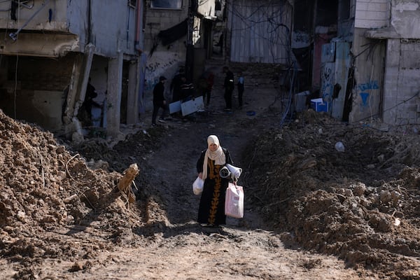 Residents of the West Bank urban refugee camp of Nur Shams evacuate their homes and carry their belongings as the Israeli military continues its operation in the area on Wednesday, Feb. 26, 2025. (AP Photo/Majdi Mohammed)