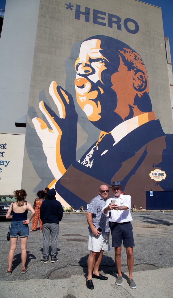 Bob Henkel (left) and Burl Salmon take a selfie in front of the large John Lewis mural on Auburn Avenue in Atlanta on Saturday, July 18, 2020.  (Photo: Steve Schaefer for The Atlanta Journal-Constitution)