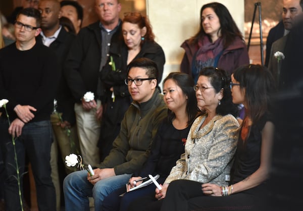 Relatives, friends and neighbors gather for a candlelight vigil honoring Trinh Huynh at the lobby of the 999 Building in Midtown Atlanta on Thursday, April 6, 2017. HYOSUB SHIN / HSHIN@AJC.COM