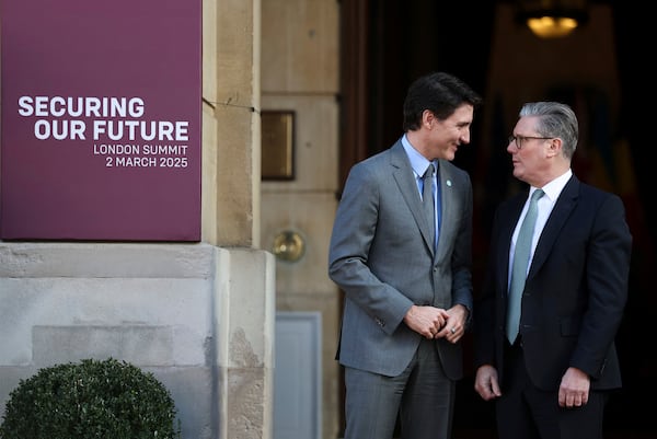 Britain's Prime Minister Keir Starmer, right, welcomes Canadian Prime Minister Justin Trudeau to the European leaders' summit to discuss Ukraine, at Lancaster House, London, Sunday March 2, 2025. (Toby Melville/Pool via AP)