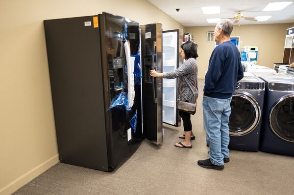 Marcia Davis and her father Rafael Buxo look at a refrigerator at Mitchell Appliance Company in Douglasville on Thursday afternoon, Nov. 5, 2020. Normally the store would stock five or six different models, but they currently only have two. Co-owner Vickie Mitchell said she is having a hard time getting appliances because the pandemic has slowed manufacturing. Davis and her father left and said they would come back when there was more of a selection. Ben Gray for the Atlanta Journal-Constitution