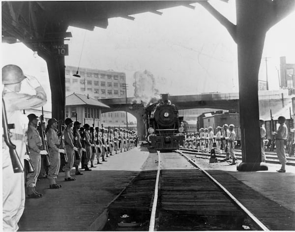 April 1945 -- An armed guard from Camp Sibert presents arms as the special funeral train bearing the body of President Roosevelt pulls into Atlanta's Terminal Station on its way from Warm Springs, Ga., to Washington, D.C.