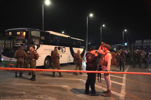 Israeli security forces work at the scene of a shooting attack on a bus near the West Bank town of Beit Jala, early Thursday, Dec. 12, 2024. (AP Photo/Mahmoud Illean)