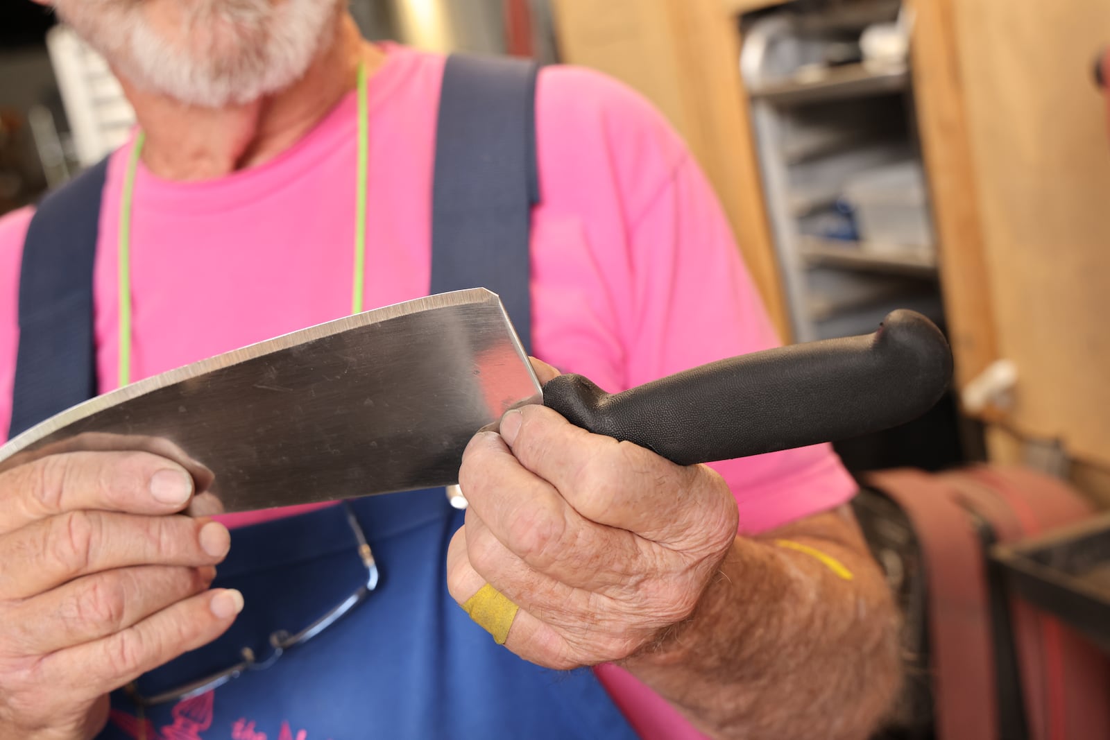 Geoff Edges cuts the corner off the heel of a blade, because that is the sharpest part of knife and can lead to injury. Tyson Horne/tyson.horne@ajc.com
