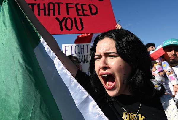 Pro-immigration protesters march along Buford Highway as they waving flags from Mexico, Cuba, Guatemala and Puerto Rico, and carrying signs condemning deportations, Saturday, February 1, 2025, in Atlanta. About 1,000 protesters on Saturday gathered along Buford Highway, the immigrant hub of metro Atlanta, to call for an end to the targeted operations by immigration agents that began last week. (Hyosub Shin / AJC)