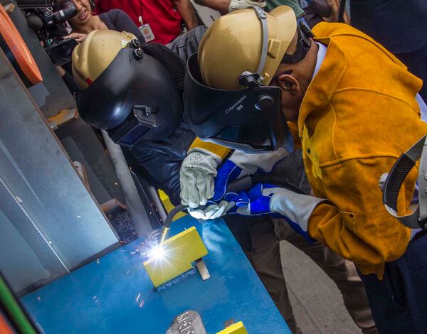 Rep. John Lewis participated in a naming ceremony at the General Dynamics NASSCO shipyard in San Diego on May 13, 2019, when he welded his initials onto the 742-foot-long refueling vessel dedicated to him. (Photo courtesy of General Dynamics NASSCO)