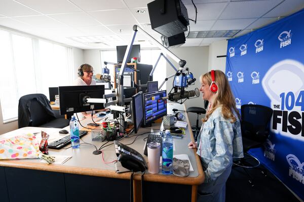 Kevin Avery (left) and Taylor Scott, the first two employees at Fish when the station went on air in October 2000, were thrilled they were able to give their listeners an extended sendoff. (Jason Getz/AJC)