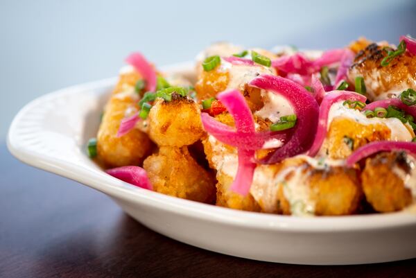 Lagarde totchos with pimento Cheese and ranch, pickled red onions and scallions.