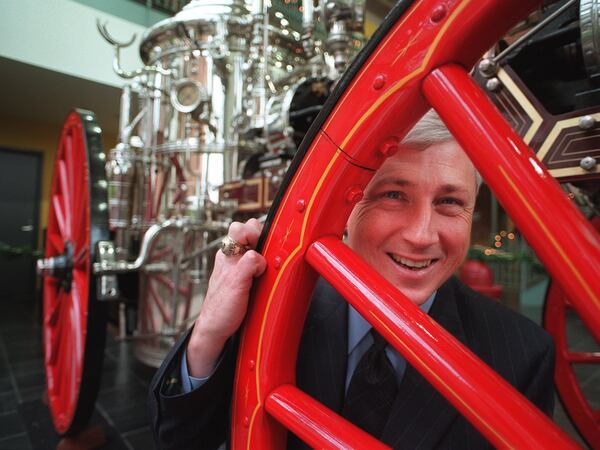 This 1999 photo was taken when Gibbs was named fire chief. He is posing at the fire department's own museum with their 1879 steam engine called the Aurora. (Andy Sharp/AJC)