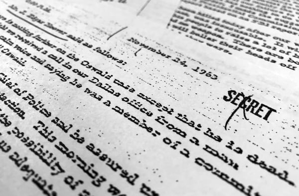 FILE - Part of a file, dated Nov. 24, 1963, quoting FBI director J. Edgar Hoover as he talks about the death of Lee Harvey Oswald, is photographed in Washington, Oct. 26, 2017. (AP Photo/Jon Elswick, File)