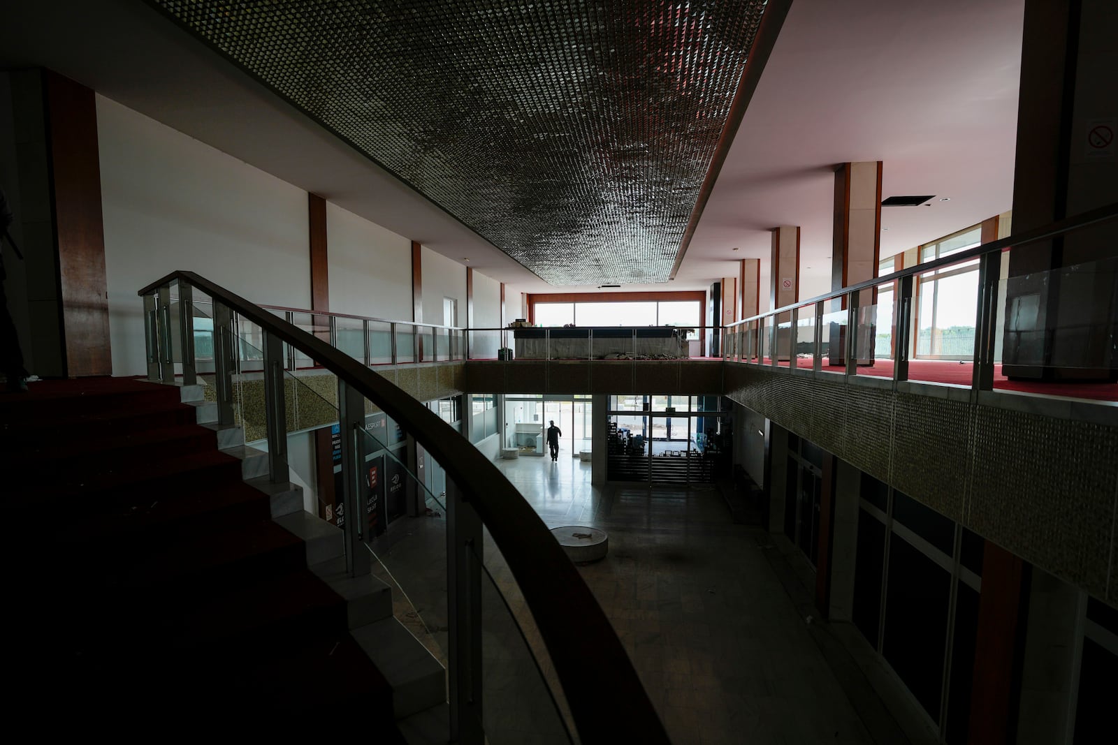 A security worker walks through Hotel Yugoslavia, once a symbol of progress in the former socialist state of Yugoslavia that broke apart in the 1990s and a favorite gathering place for local residents as well as world leaders, in Belgrade, Serbia, Thursday, Oct. 3, 2024. (AP Photo/Darko Vojinovic)