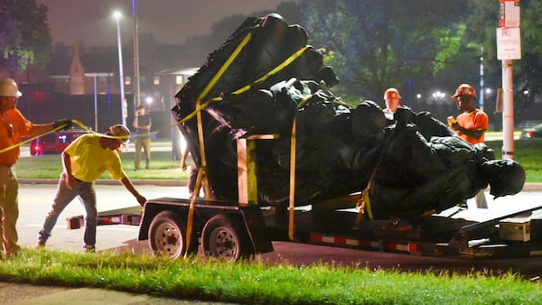 Workers remove a monument dedicated to the Confederate Women of Maryland early Wednesday, Aug. 16, 2017, after it was taken down in Baltimore. Local news outlets reported that workers hauled several monuments away early Wednesday, days after a white nationalist rally in Virginia turned deadly. (Jerry Jackson/The Baltimore Sun via AP)