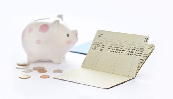 Saving account passbook, book bank and piggy bank on white background