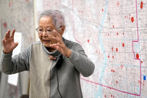 Shizuyo Takeuchi, 94-year-old Tokyo raid survivor, shares her experience in front of a map of the areas damaged during the 1945 Tokyo Firebombing at the Center of the Tokyo Raids and War Damage on Feb. 24, 2025, in Tokyo. (AP Photo/Eugene Hoshiko)