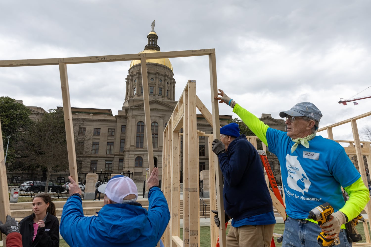 Habitat for Humanity volunteers take down the frame of a home built at Liberty Plaza, outside the Capitol, in Atlanta on Wednesday, March 5, 2025. The frame will be transported and used to house a family. (Arvin Temkar / AJC)