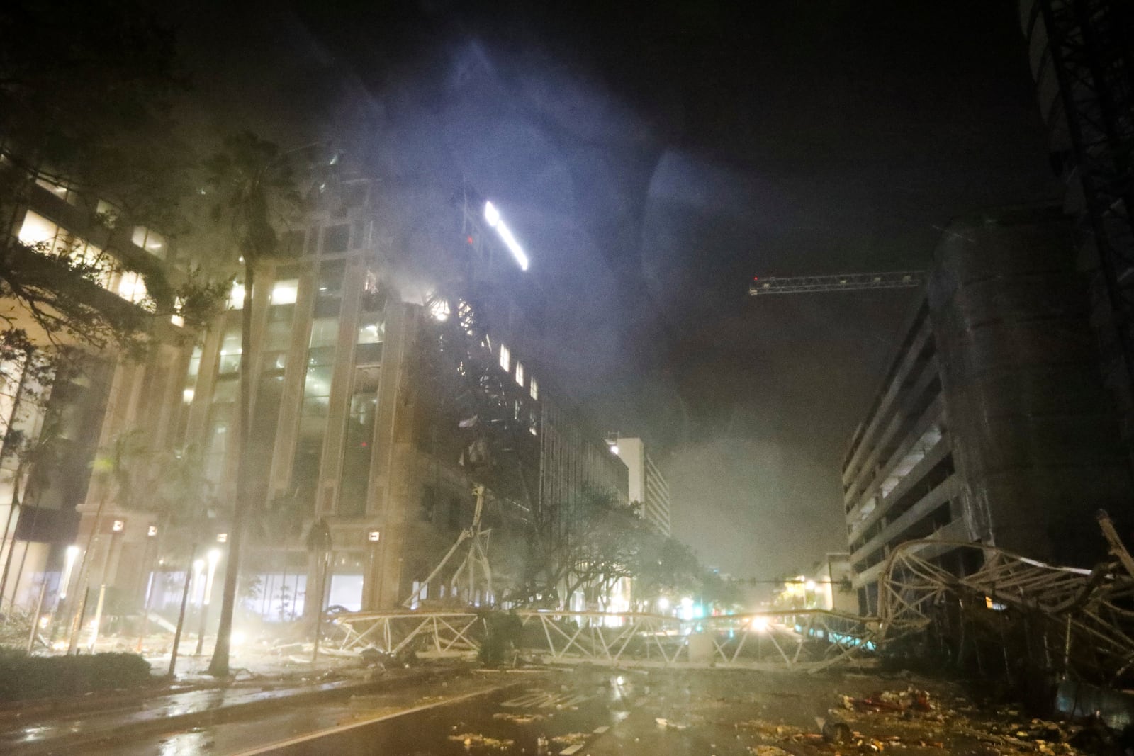 A crane is seen across 1st Avenue South near the Tampa Bay Times offices in St. Petersburg, Florida, Thursday, Oct. 10, 2024, as Hurricane Milton's strong winds tore through the area. (Chris Urso/Tampa Bay Times via AP)