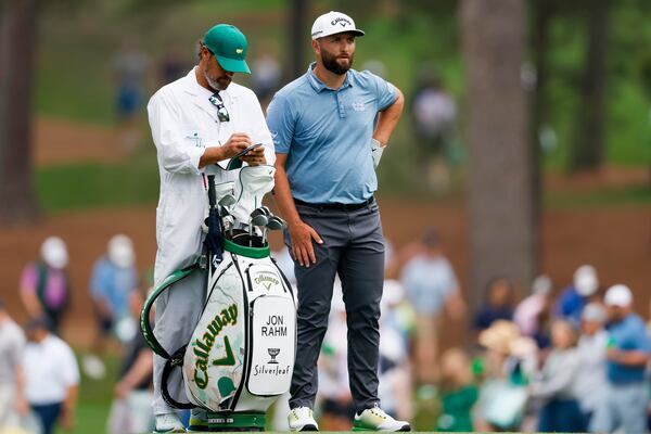 Jon Rahm talks with his caddie Adam Hayes before he hits his second shot on the 17th fairway during the practice round for the 2023 Masters Tournament at Augusta National Golf Club, Tuesday, April 4, 2023, in Augusta, Ga. Jason Getz / Jason.Getz@ajc.com)
