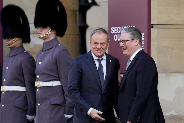 Britain's Prime Minister Keir Starmer, right, greets Poland's Prime Minister Donald Tusk as he arrives for a summit on Ukraine at Lancaster House in London, Sunday, March 2, 2025. (AP Photo/Christophe Ena, Pool)