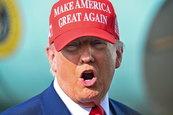 President Donald Trump speaks to reporters after landing at Palm Beach International Airport in West Palm Beach, Fla ., Sunday, Feb. 16, 2025, after attending the NASCAR Daytona 500 auto race. (Pool via AP)