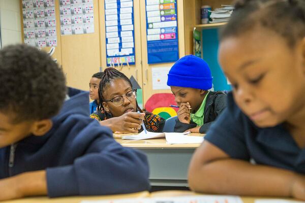 Harper-Archer Elementary school teacher Nicole Moneyham (left) helps her student Kameron Delancy (right) as they review a writing comprehension assignment during class at Harper-Archer Elementary School in Atlanta, Wednesday, February 26, 2020. (ALYSSA POINTER/ALYSSA.POINTER@AJC.COM)