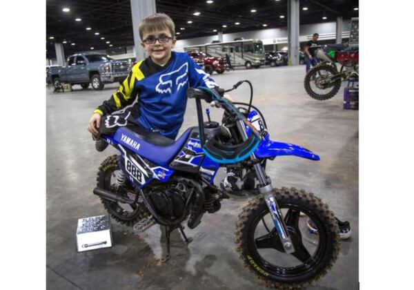 Four-year-old Levi Cornett stands by his bike while he waits for his turn to rase during the Supercross Amateur racing event at the Mercedes-Benz Stadium on Sunday, March 4, 2018. Cornett is the youngest rider to ride in this year's event. STEVE SCHAEFER / SPECIAL TO THE AJC