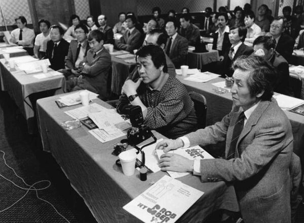 Korean businessmen listen to local police give crime prevention tips in a Sunday session in 1986. (Bill Mahan / AJC Archive at GSU Library AJCP159-043a)