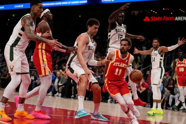 Atlanta Hawks guard Trae Young (11) looks to pass in the first half of an NBA basketball game against the Milwaukee Bucks, Tuesday, March 4, 2025, in Atlanta. (AP Photo/Brynn Anderson)