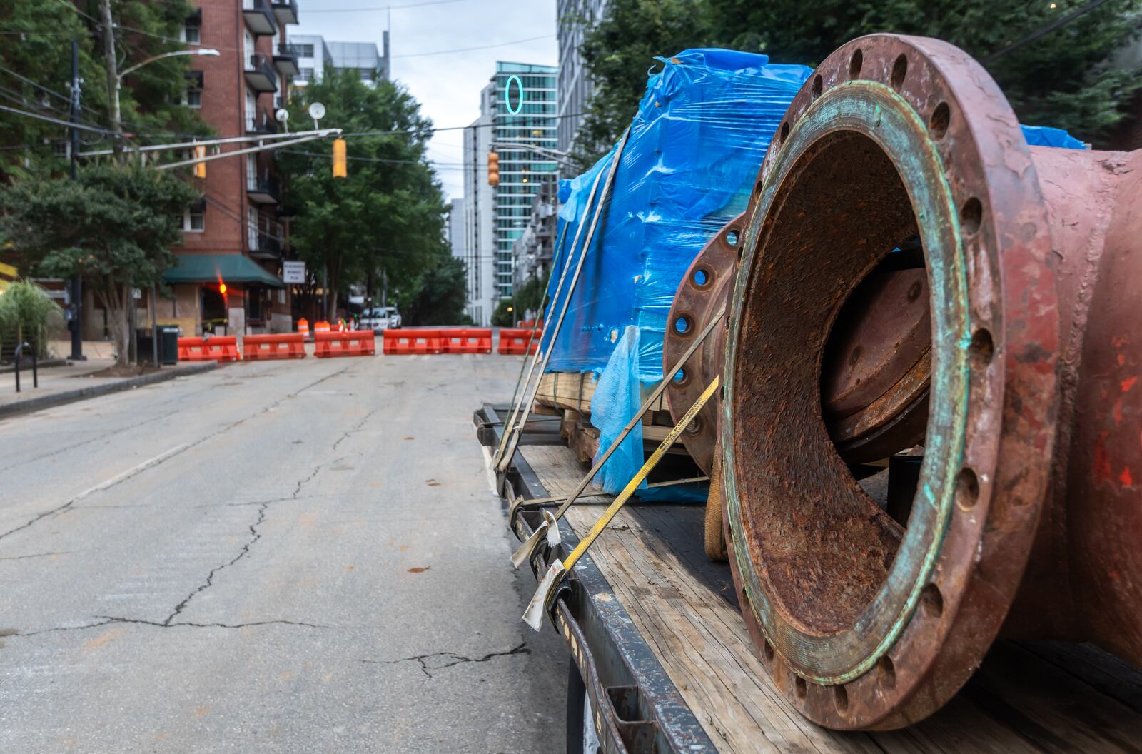 Water repair equipment on a flatbed was all the equipment left to see at the infamous 11th Street water main break Thursday morning, June 6, 2024. Thursday morning, the city announced that the boil water advisory had been lifted, six days after the ordeal began. Now, the focus is on fixing the outdated infrastructure. Atlanta Mayor Andre Dickens said he will rely on the experts and how the city will proceed. (John Spink/AJC)