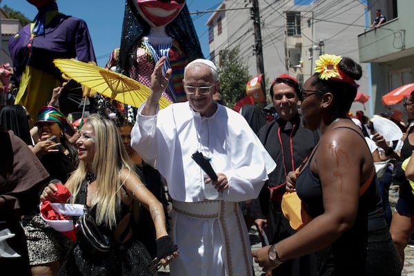 Reveler Fernando Coelho, dressed as a pope, takes part in the Carmelitas street party on the first official day of Carnival in Rio de Janeiro, Friday, Feb. 28, 2025. (AP Photo/Bruna Prado)