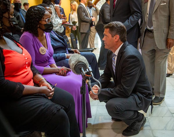 Lt. Gov. Geoff Duncan talks with Wanda Cooper-Jones after the signing earlier this month of House Bill 479, which repeals Georgia's citizen's arrest law. STEVE SCHAEFER FOR THE ATLANTA JOURNAL-CONSTITUTION