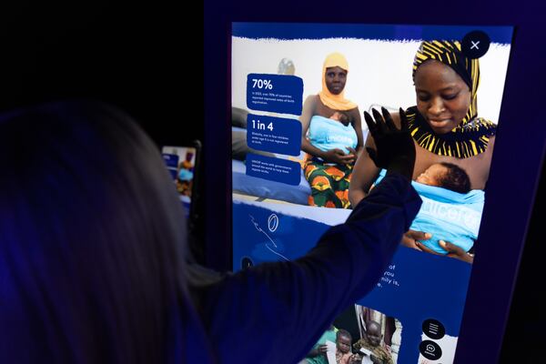 Atlanta Daily World reporter Hunter Gilmore previews UNICEF USA’s experience for children and families, called "Heart Strings: Creating Connection to the World’s Children," at Pullman Yards in Atlanta on Thursday, April 18, 2024. (Arvin Temkar / arvin.temkar@ajc.com)