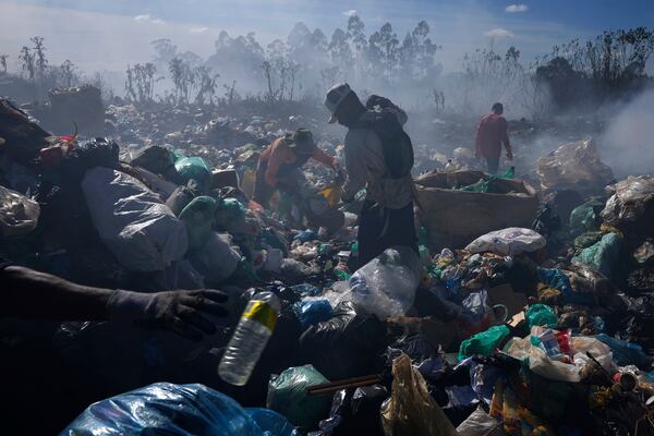 FILE - Recyclable collectors work at the Lixao open-air dump in Santo Antonio do Descoberto, Goias state, Brazil, June 4, 2024. (AP Photo/Eraldo Peres, File)