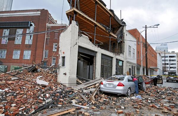 Michael Wesley (leaning into silver Honda) said his "one goal" on March 15, 2008 was to retrieve his Wii out of the trunk of his destroyed vehicle on Nassau Street in downtown Atlanta on Saturday.