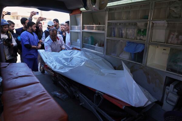 The body of United Nations Mine Action Service (UNMAS) worker is taken into the al-Aqsa Martyrs hospital after an explosion in Deir al-Balah in central Gaza, Wednesday March 19, 2025. (AP Photo/Abdel Kareem Hana)