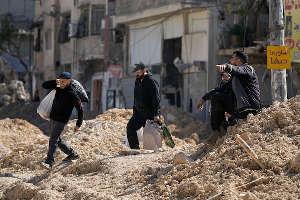 Residents of the West Bank urban refugee camp of Nur Shams evacuate their homes and carry their belongings as the Israeli military continues its operation in the area on Wednesday, Feb. 26, 2025. (AP Photo/Majdi Mohammed)