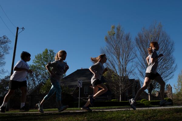 Kids with the Walton Youth Running Club work out in Marietta on Thursday, March 28, 2024.   (Ben Gray / Ben@BenGray.com)